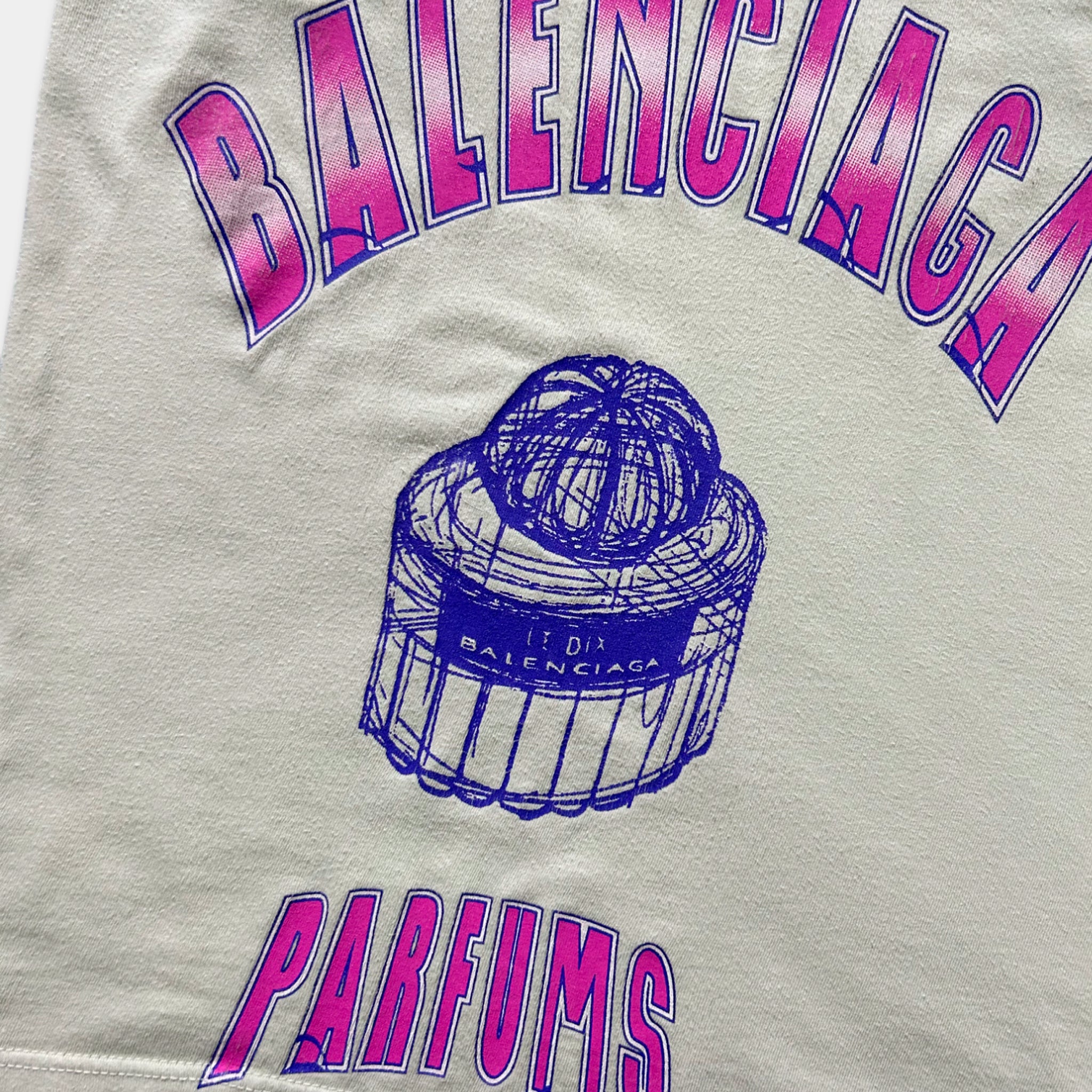 a close-up view of a white fabric with the text "BALENCIA PARFUM" printed on it, along with a graphic of a perfume bottle.