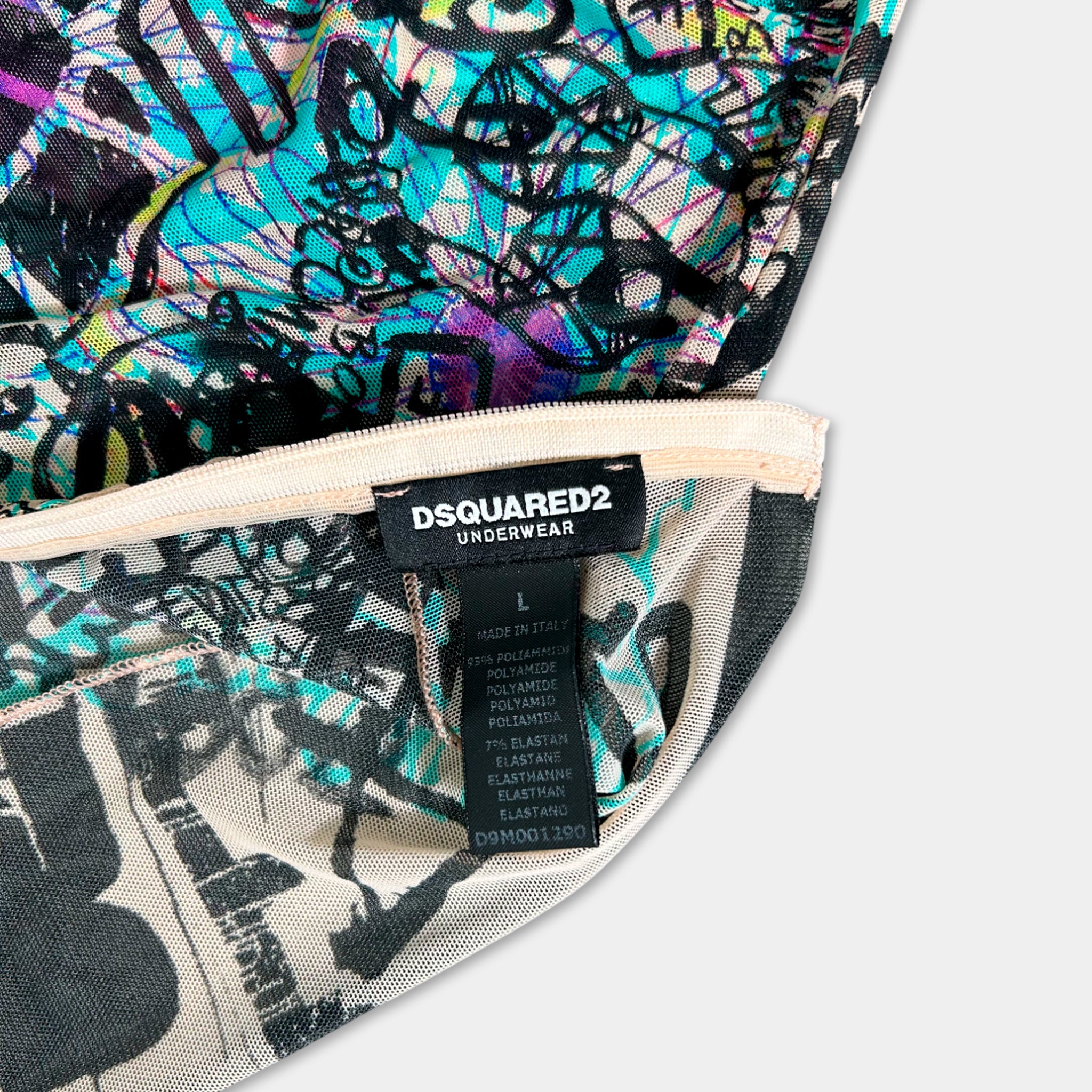 a colorful, graffiti-style pattern on a fabric, with a label attached to it that reads "DSQUARED2 UNDERWEAR".