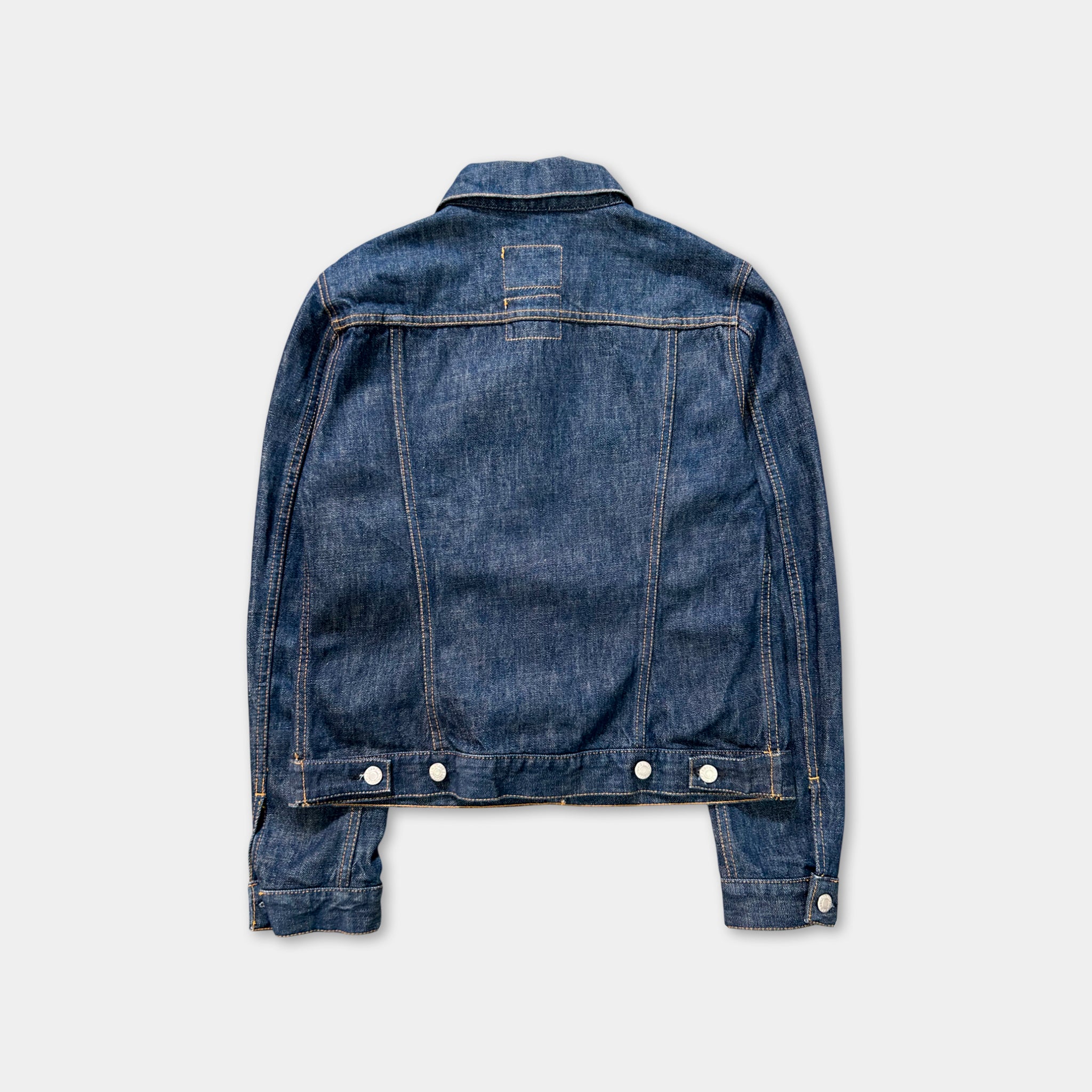 A denim jacket is shown in the image, with its back facing the viewer.