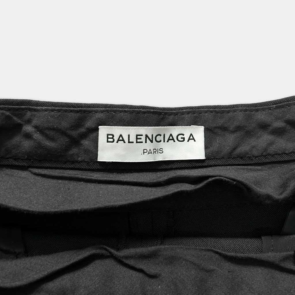 A close-up view of a black fabric, possibly a piece of clothing, with a label that reads "BALENCIAGA PARIS".