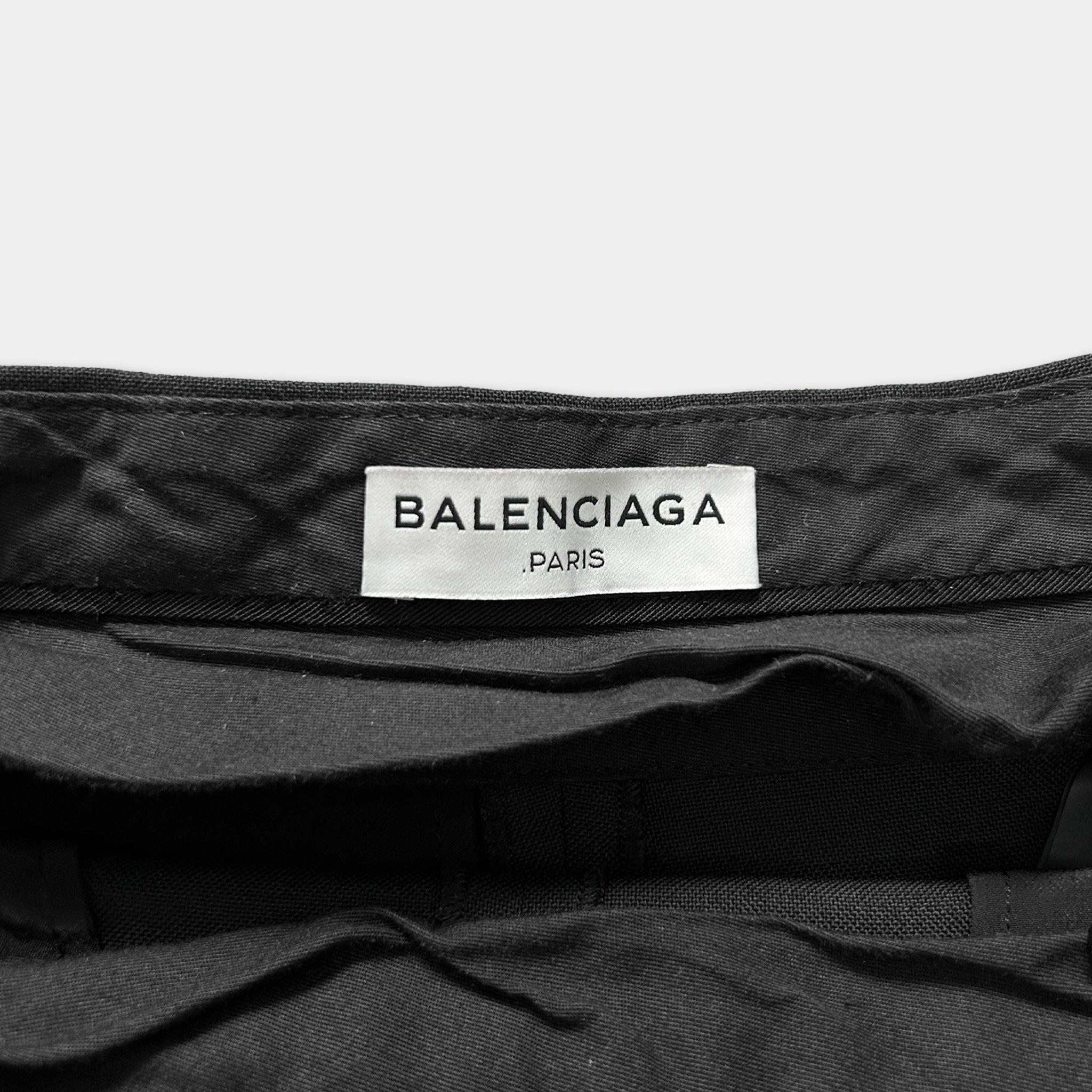 A close-up view of a black fabric, possibly a piece of clothing, with a label that reads "BALENCIAGA PARIS".