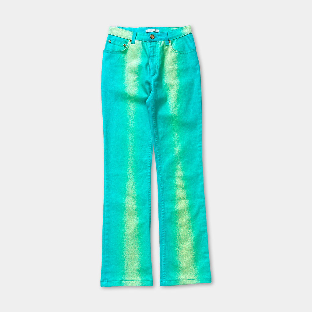 A pair of turquoise-colored jeans with a tie-dye pattern.