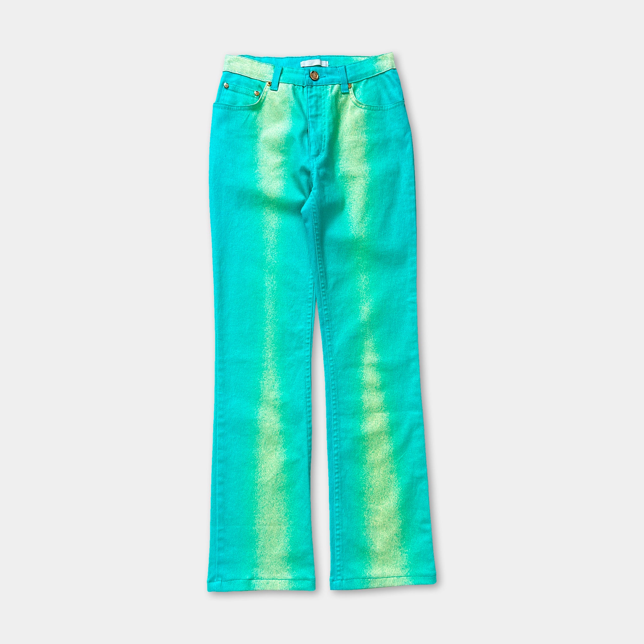 A pair of turquoise-colored jeans with a tie-dye pattern.