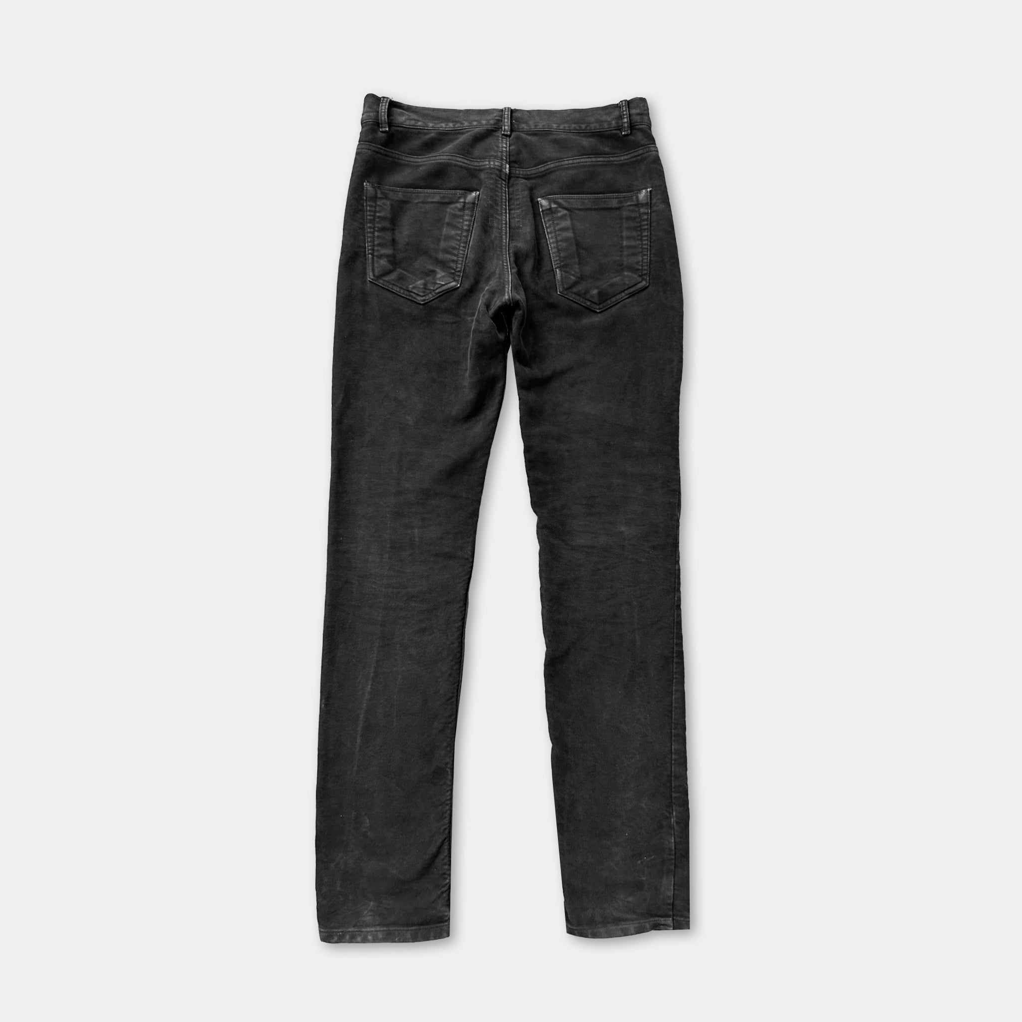 A pair of black jeans with a high waist and a button closure.