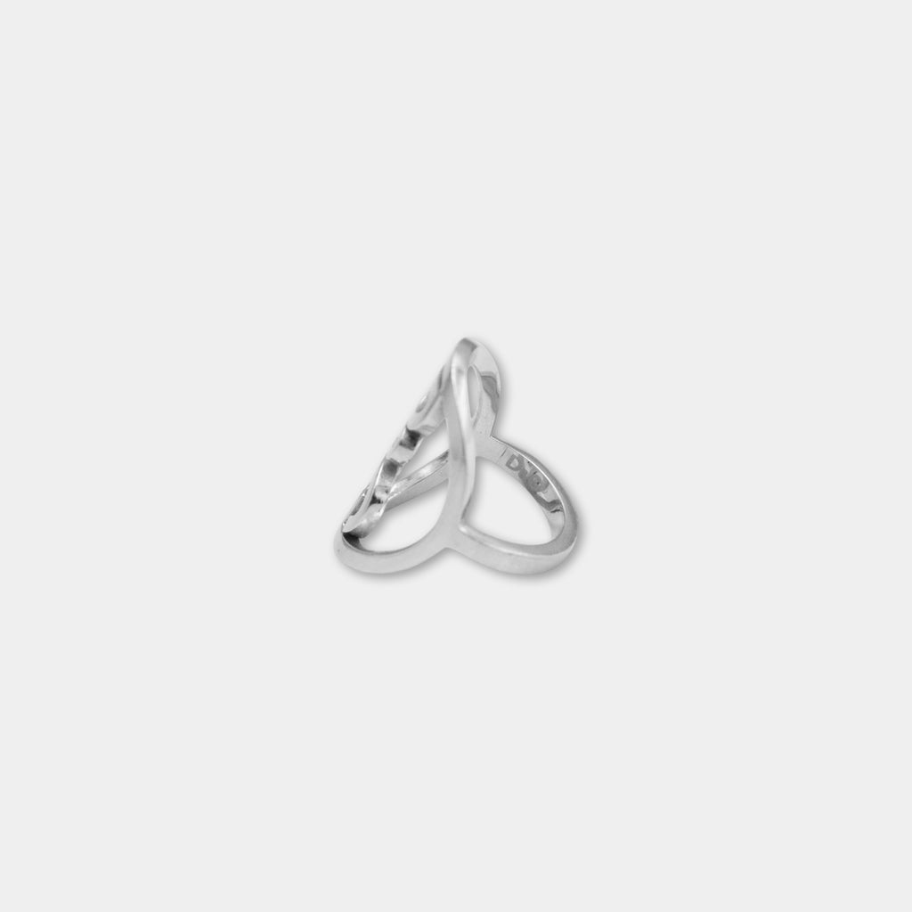 A silver ring with an intricate, twisted design.