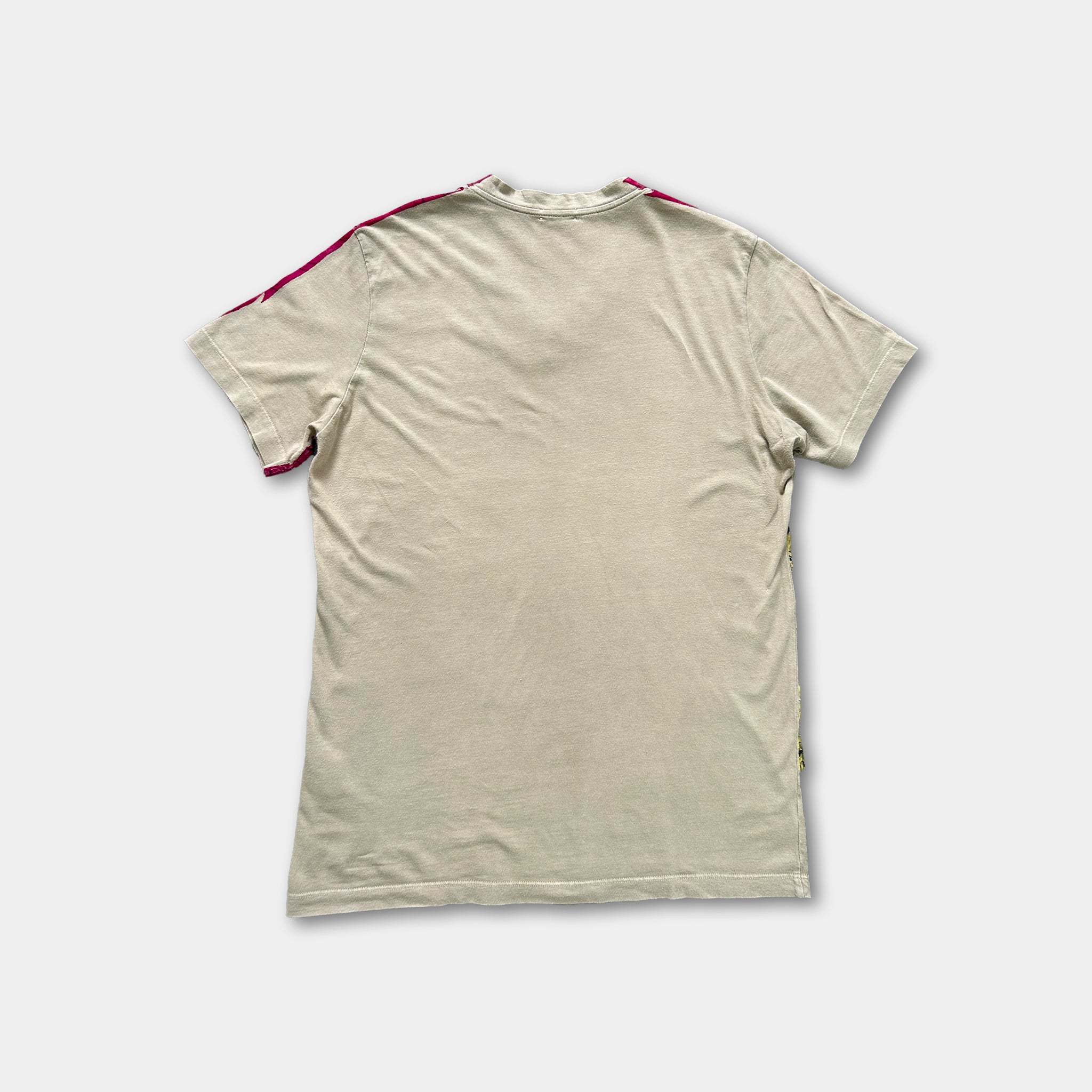 a plain, beige t-shirt with a red stripe on the sleeve.