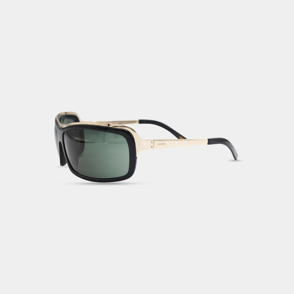 A pair of black and gold sunglasses with dark lenses.