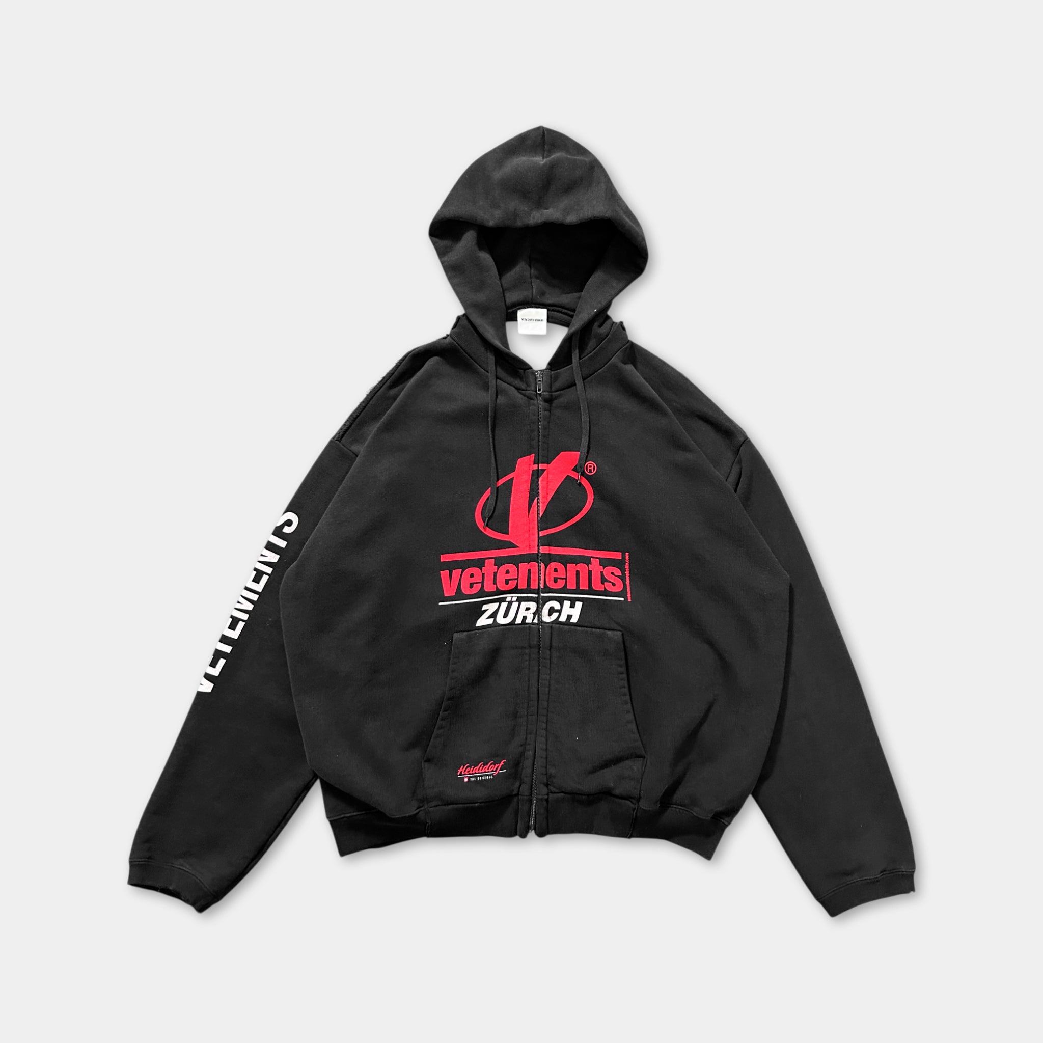 A black zip-up hoodie with the VETENENTS logo and the text "ZUR CH" printed on it.