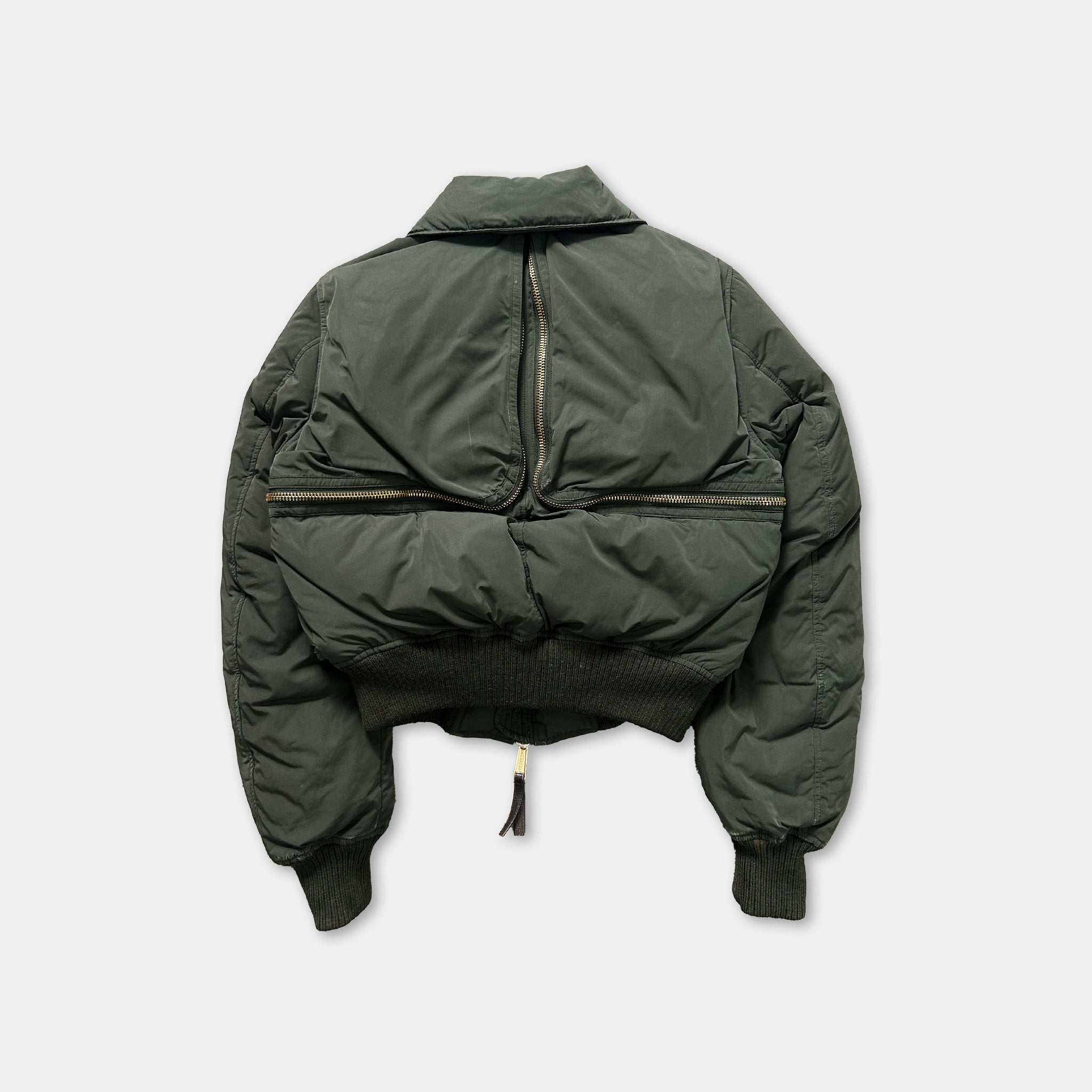 A dark green puffy jacket with a zipper running down the back.