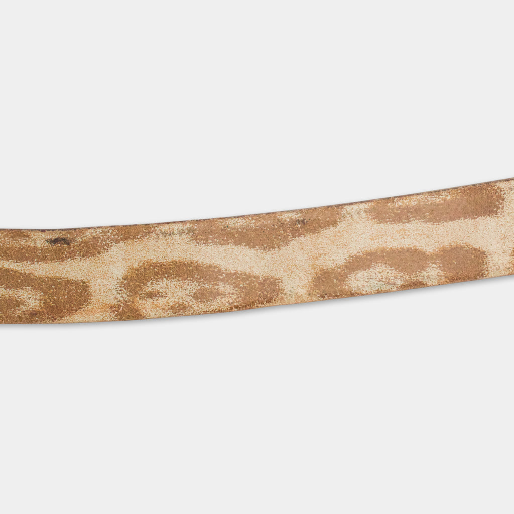 A close-up view of a brown and beige patterned belt against a white background.