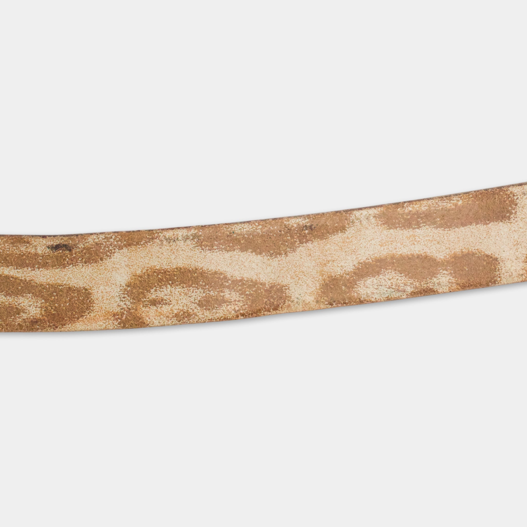 A close-up view of a brown and beige patterned belt against a white background.