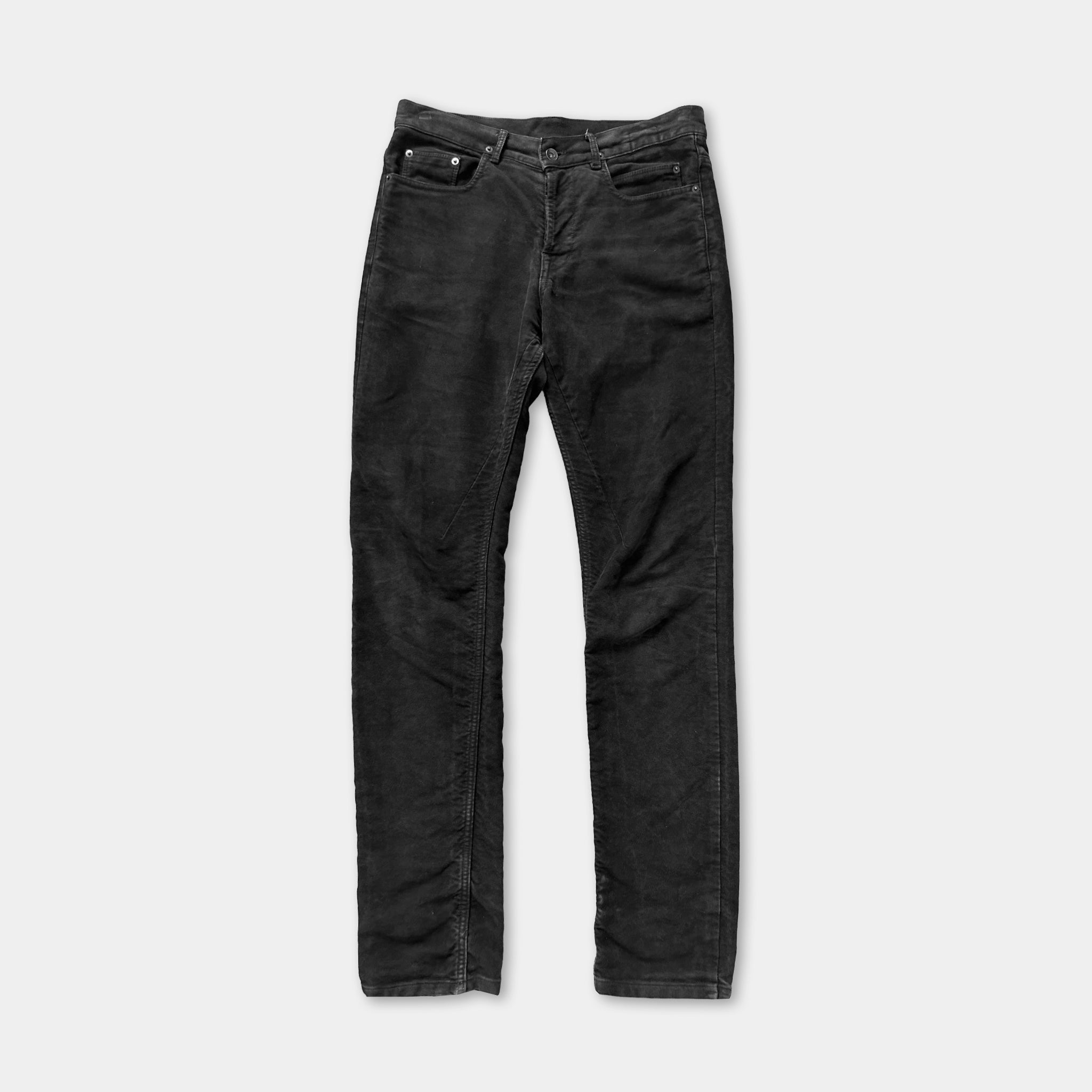 A pair of black jeans against a white background.