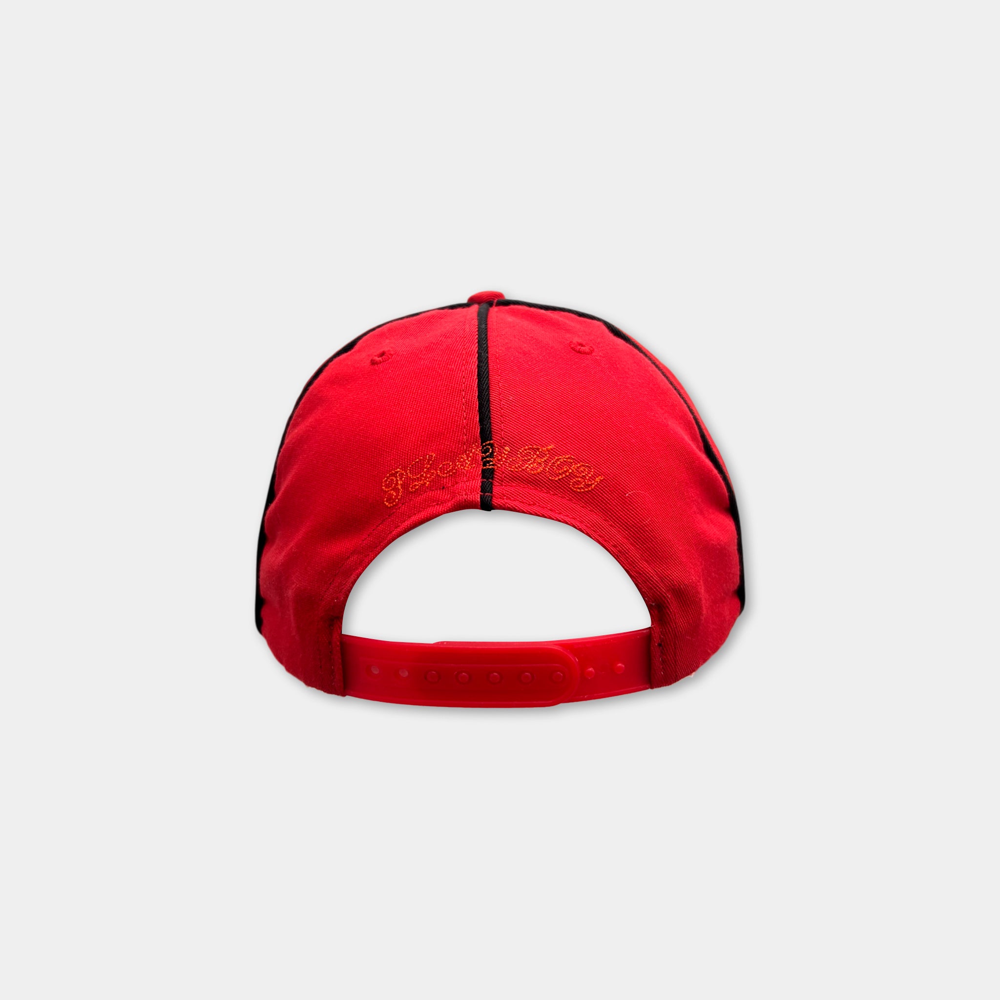 A red baseball cap with a black brim and a small embroidered logo on the front.