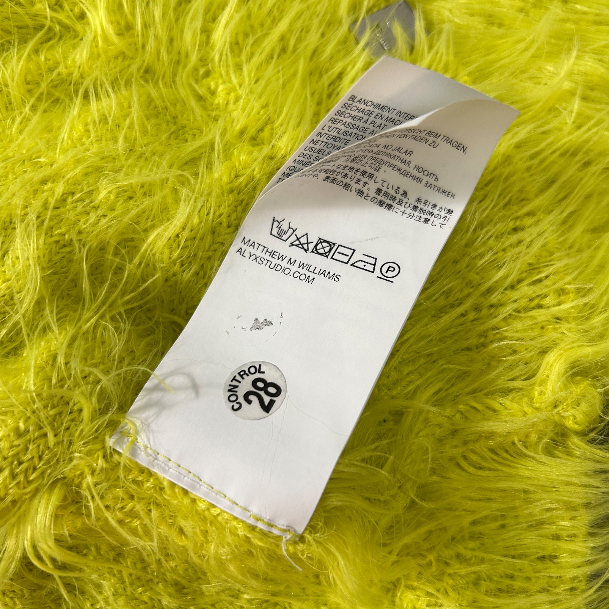a white label with black text on a yellow fuzzy surface.