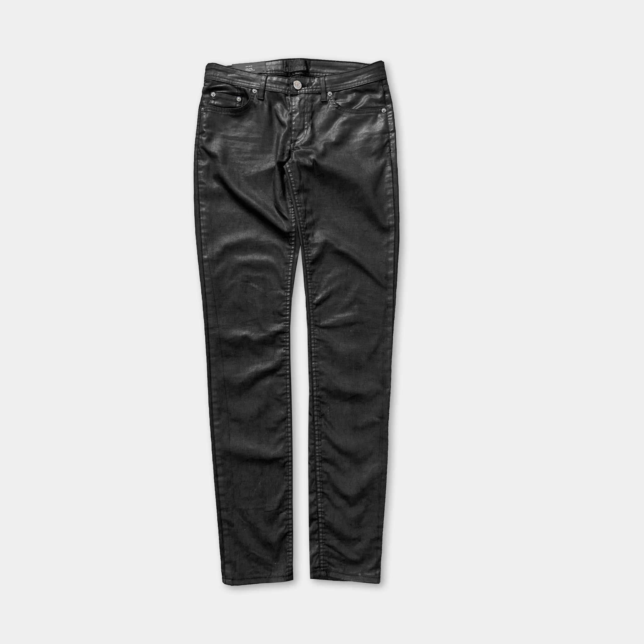 A pair of black leather jeans against a white background.