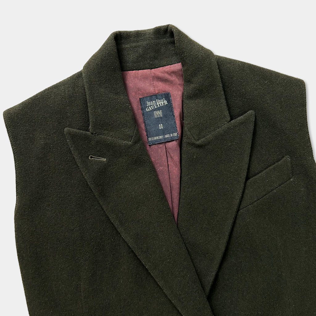 A dark green blazer with a label on the chest.