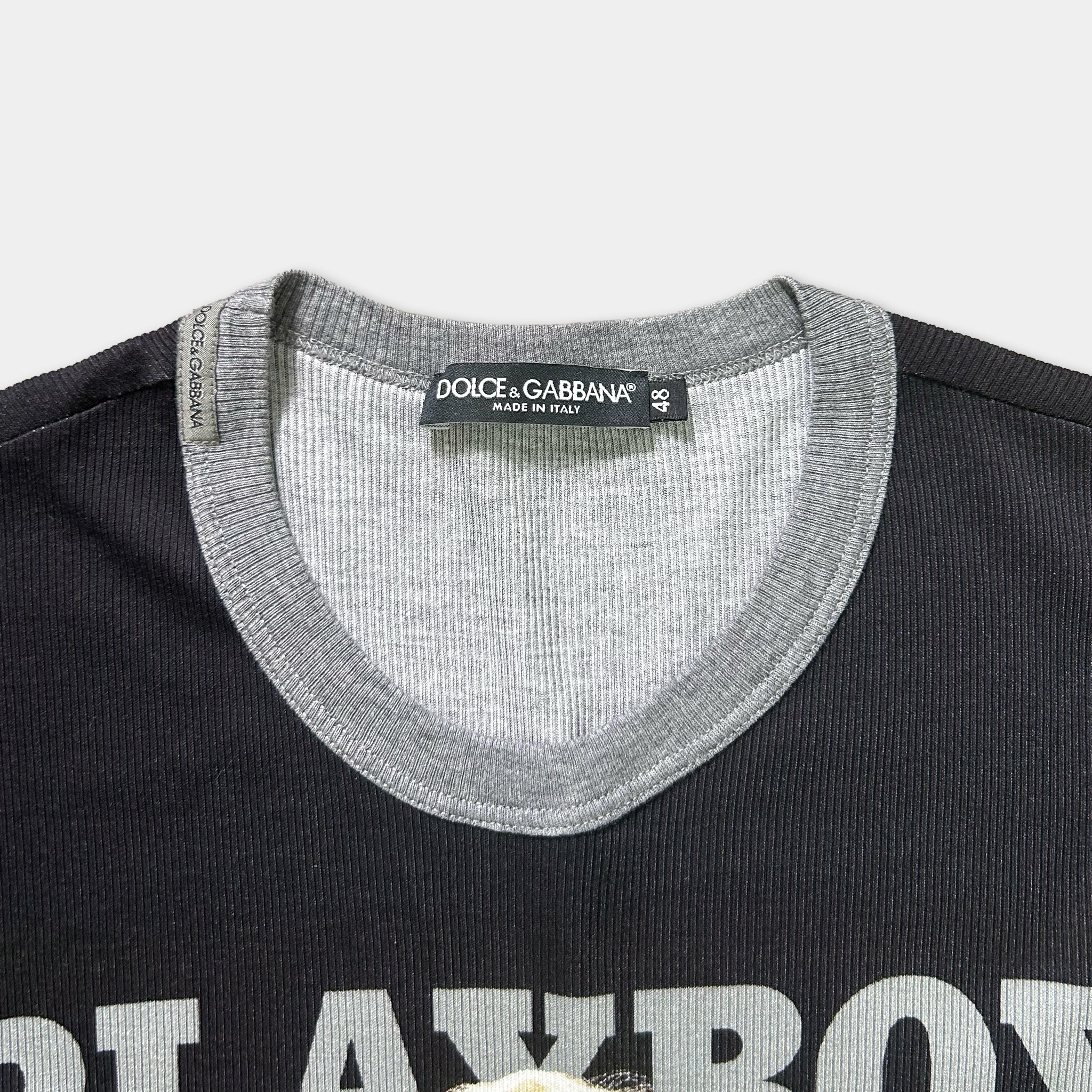 a close-up view of a black and grey t-shirt with a label on the collar.