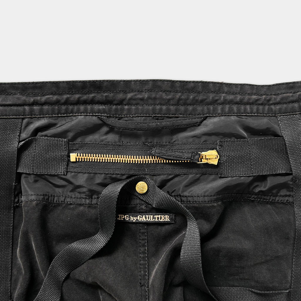a close-up view of a black fabric, possibly a piece of clothing or a bag, with a zipper and a label visible.