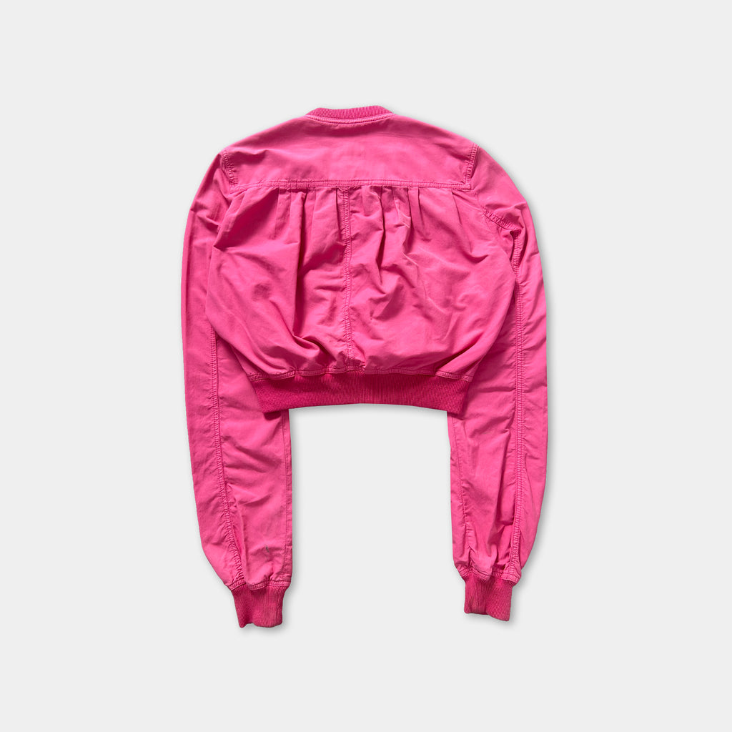 A bright pink jacket with long sleeves and a high collar is shown against a white background.