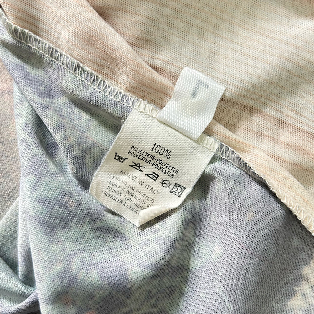 a close-up view of a fabric label with text and symbols, indicating the material and care instructions for the garment.