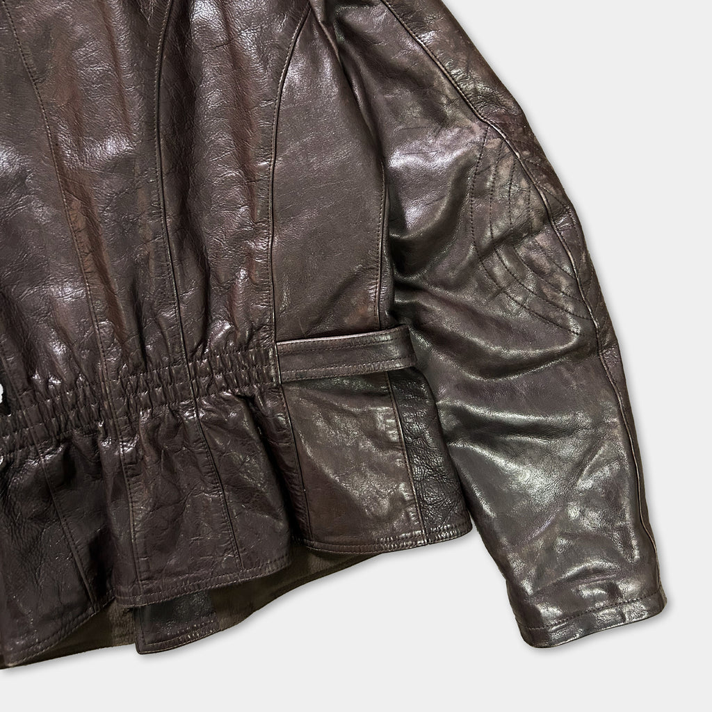 A close-up view of a brown leather jacket, showing the details of the jacket's design and texture.