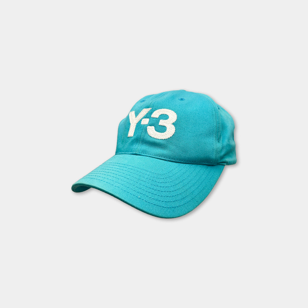 A turquoise baseball cap with the number '3' printed on it.