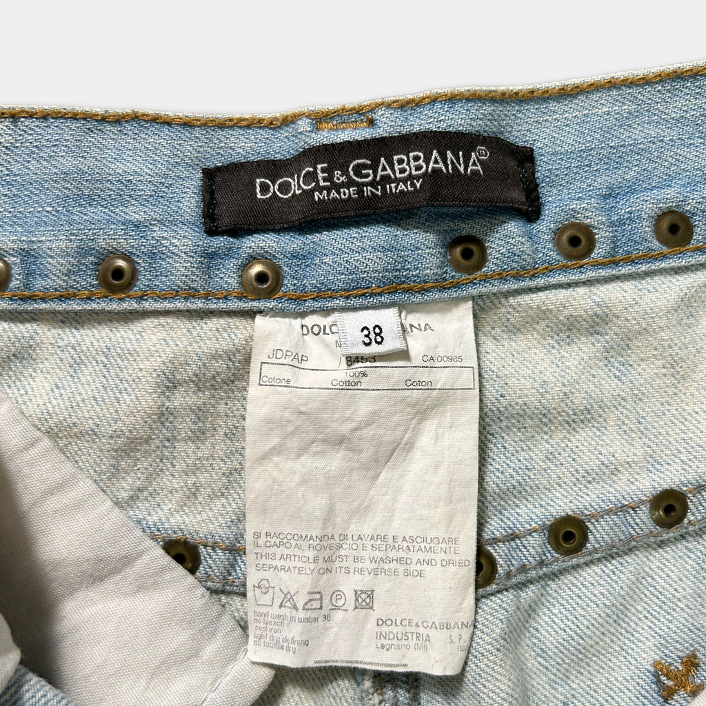 a close-up view of a pair of blue denim jeans with a label attached to the waistband, indicating the brand and the country of manufacture.