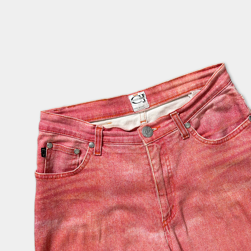 A pair of red jeans with a label on the waistband.