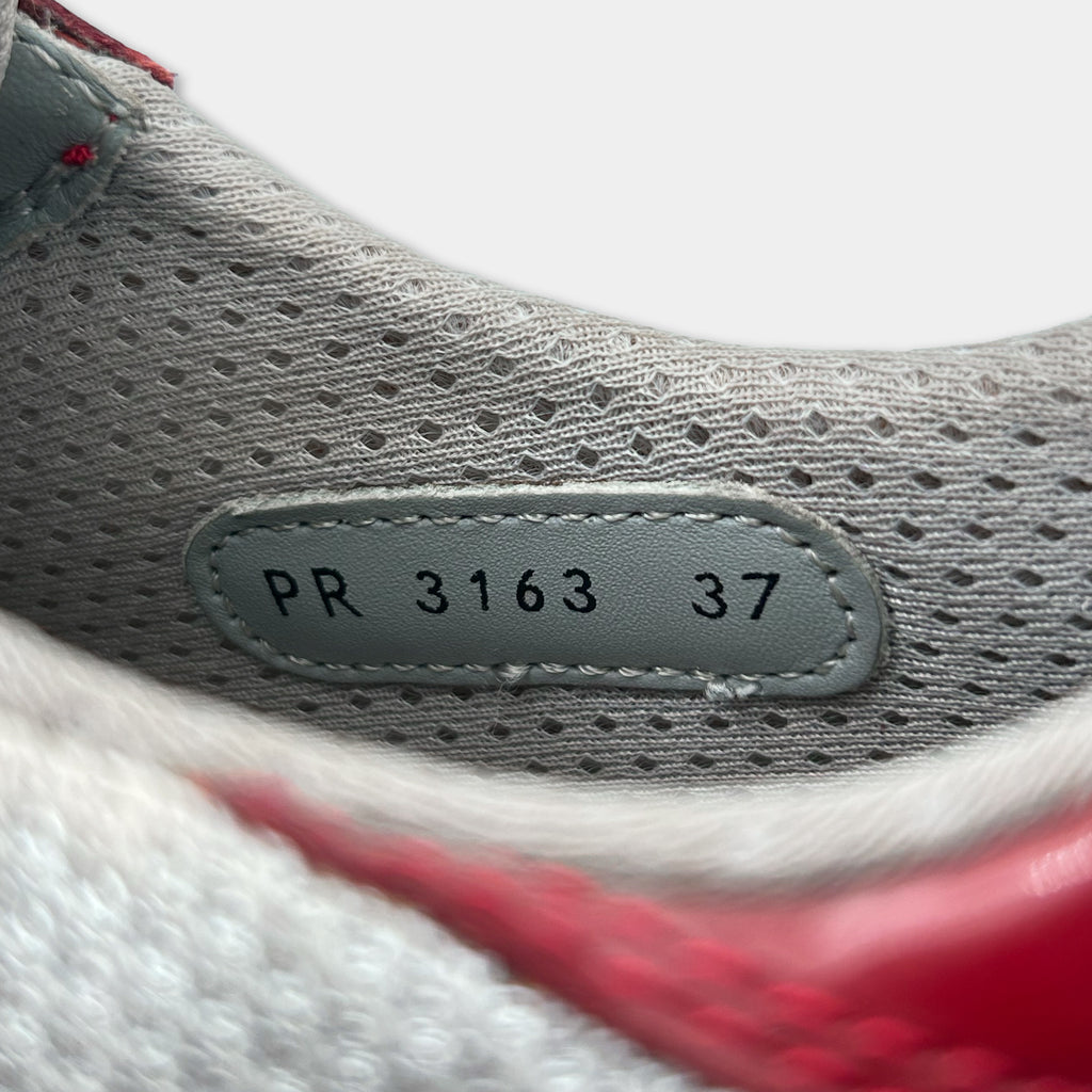 A close-up view of a shoe's sole, showing the brand name and model number PR 3163 37.