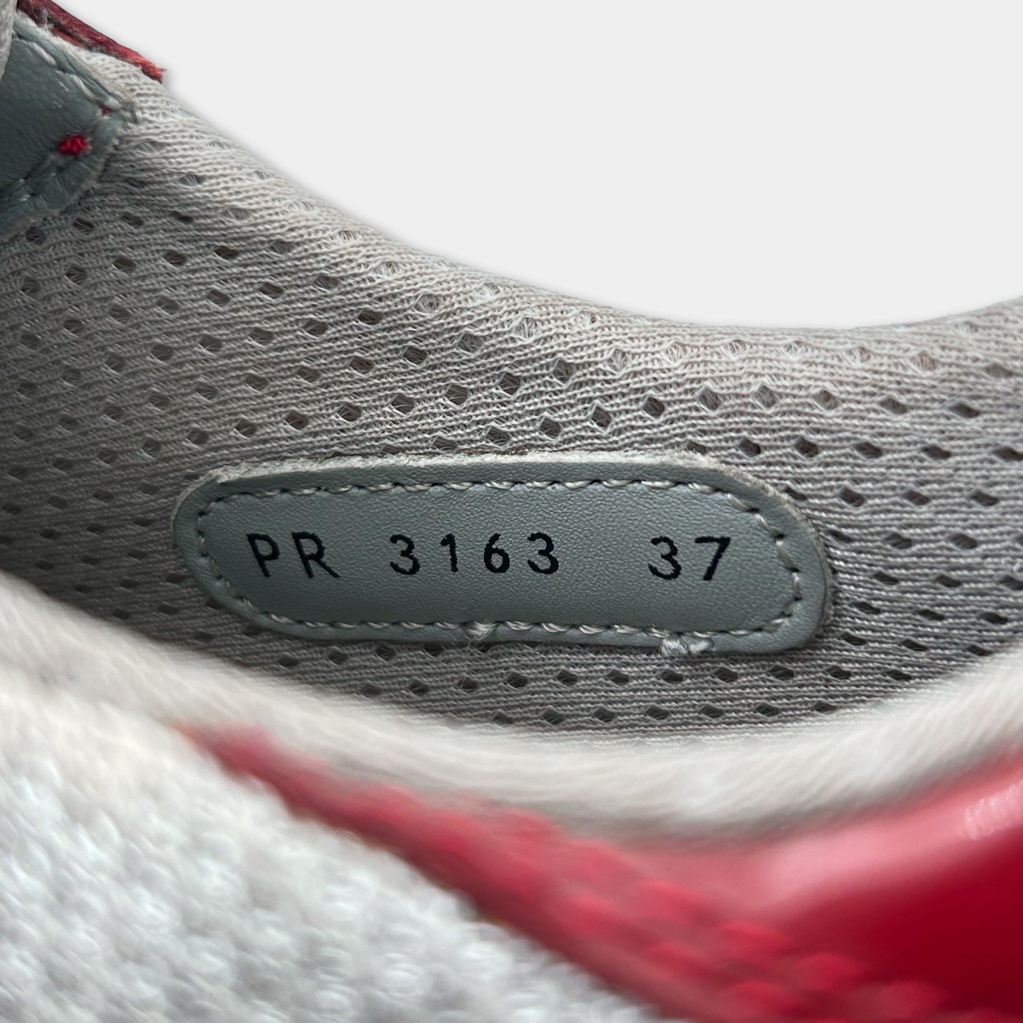A close-up view of a shoe's sole, showing the brand name and model number PR 3163 37.