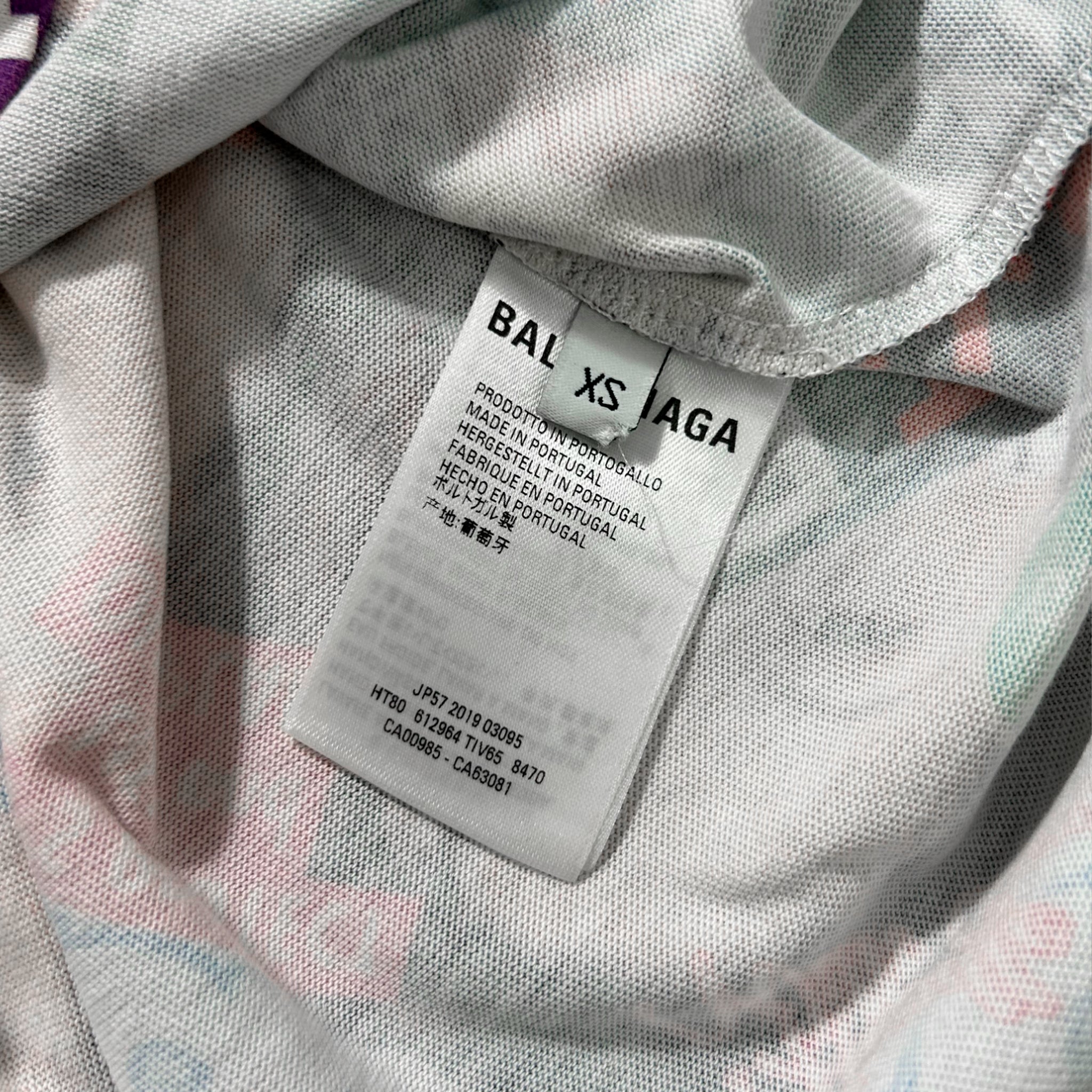 a close-up view of a white fabric with a label attached to it, which appears to be a clothing item.
