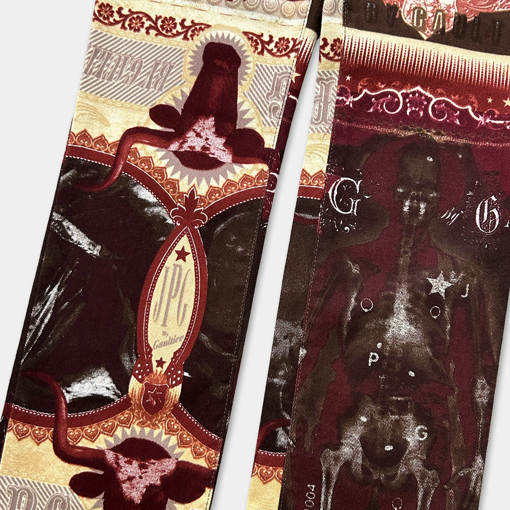 a close-up view of a decorative fabric with various patterns and designs, including images of animals and geometric shapes.