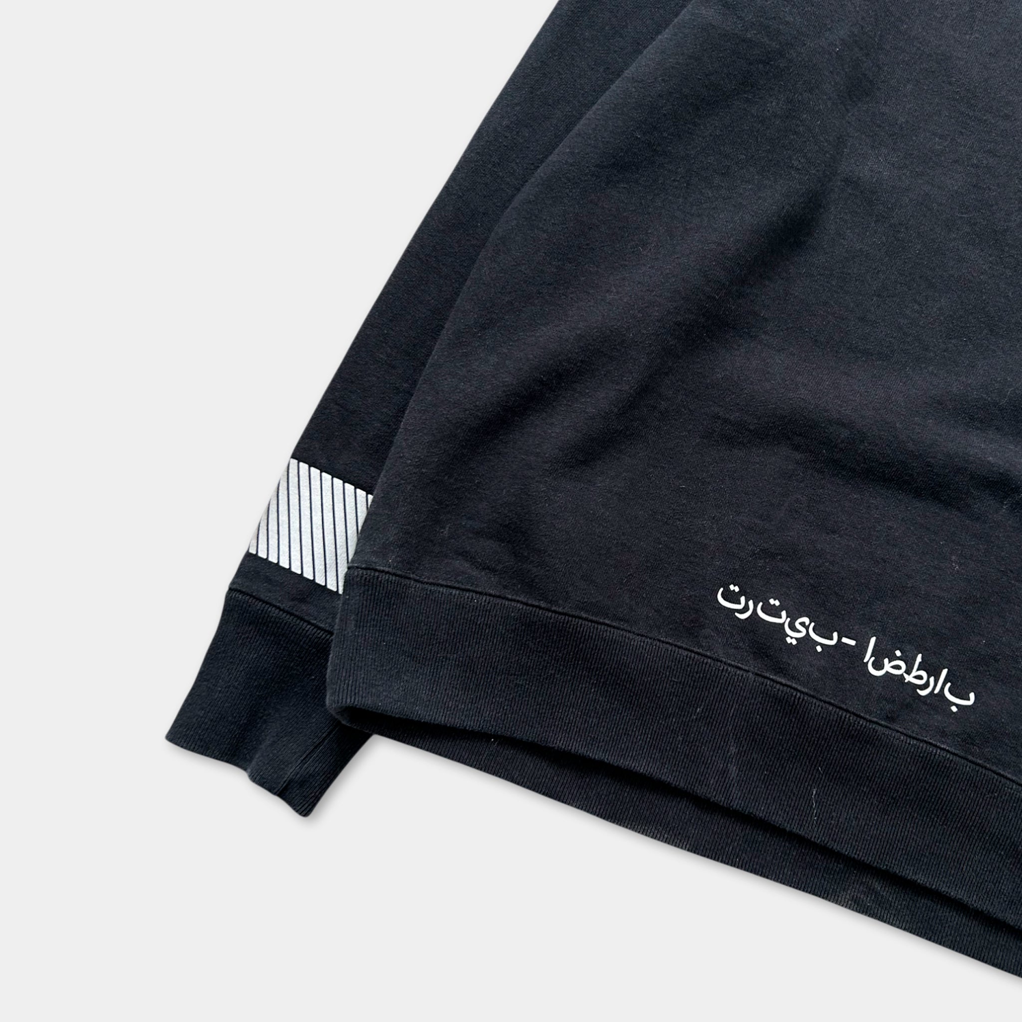 a black sweatshirt with white text on the right side.