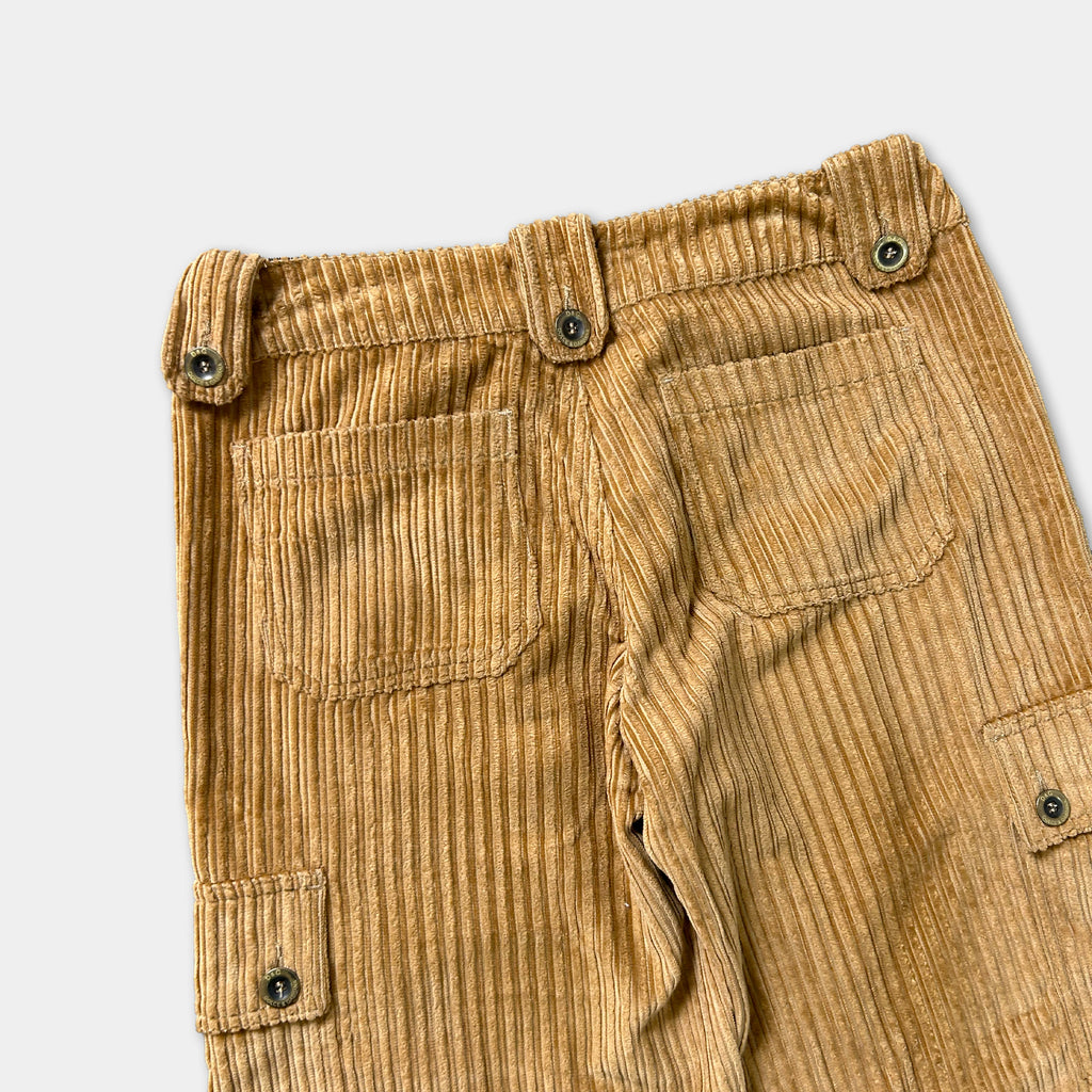 a pair of tan corduroy pants with a button closure and two pockets.