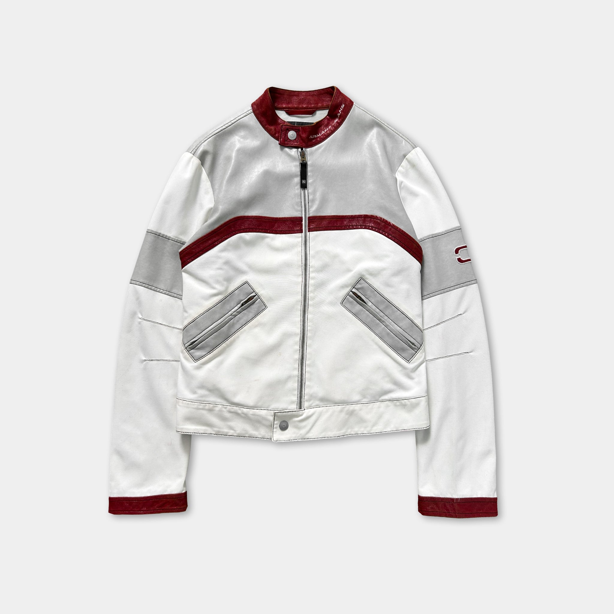 A white and red jacket with a red collar and zipper.