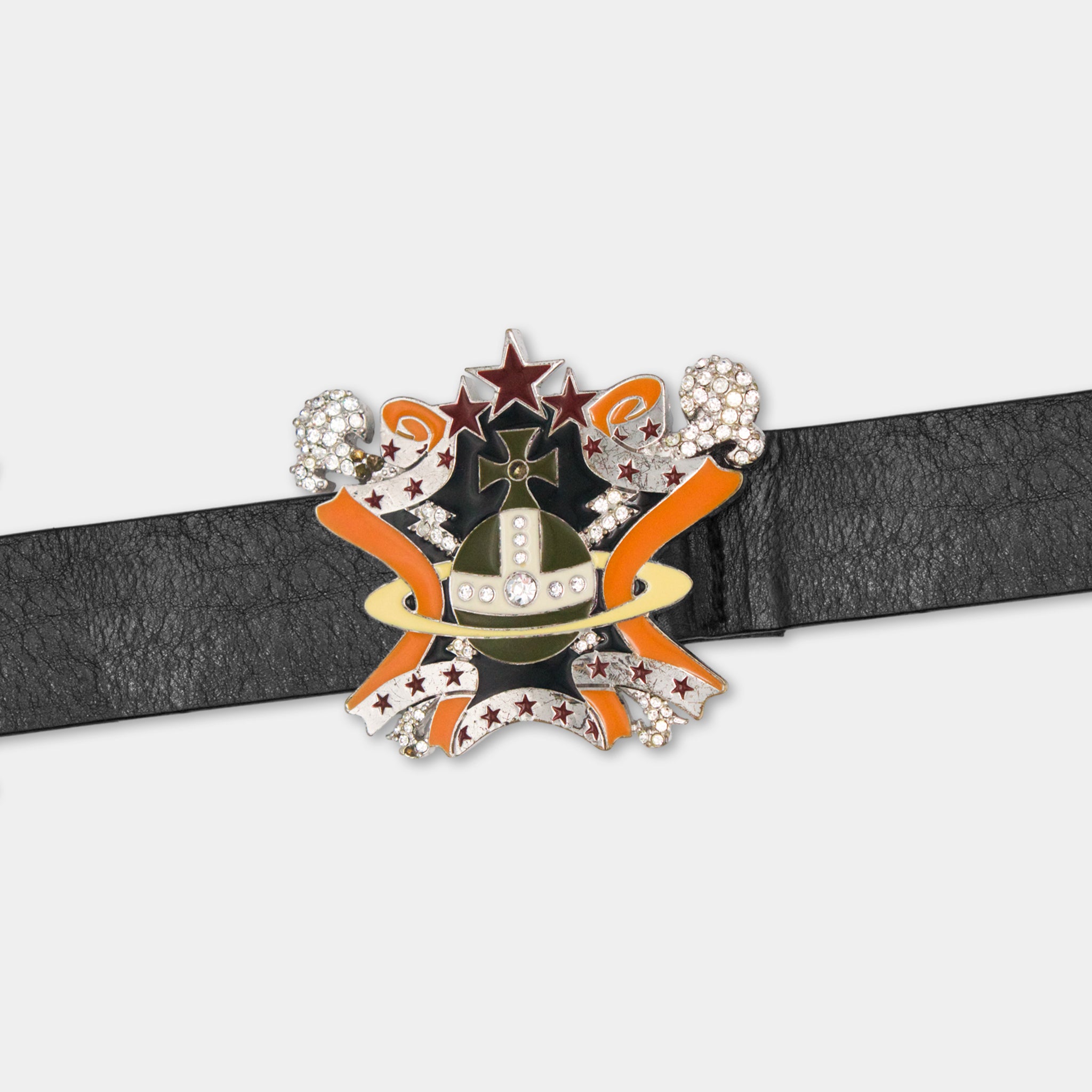 A black leather belt with a decorative metal buckle featuring a star, ribbon, and other embellishments.