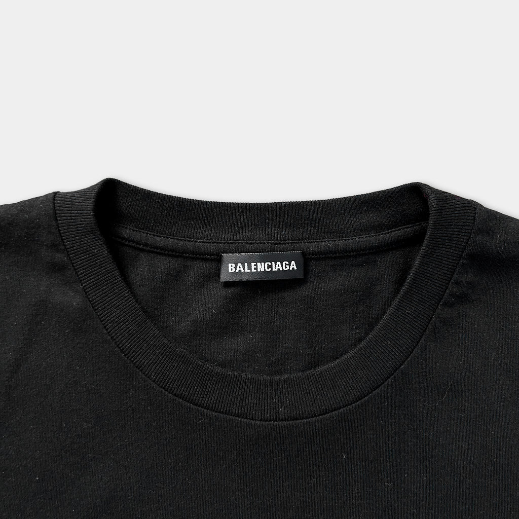 A black t-shirt with a label that says "BALENCIAGA" on the collar.