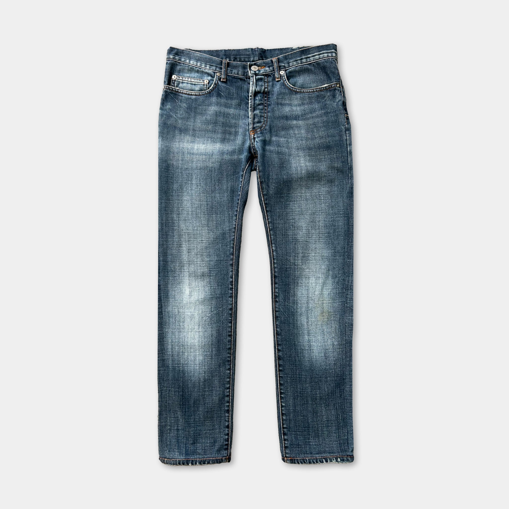 A pair of blue jeans with a classic design, featuring a pocket on the front and a zipper closure.