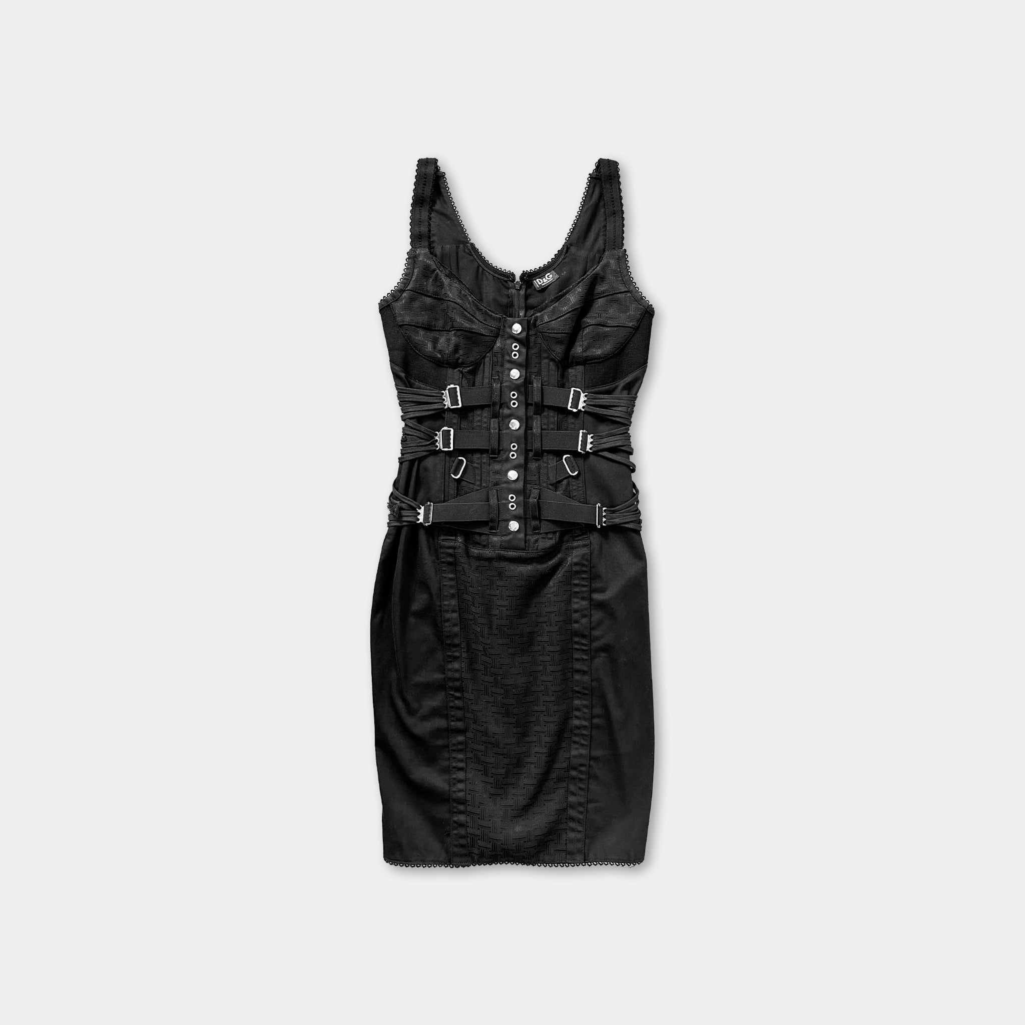 A black dress with a corset-style top and a fitted waistband.