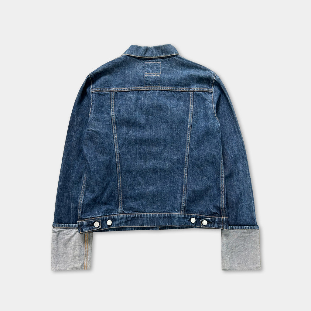A denim jacket with a button-down front and two pockets, displayed against a white background.