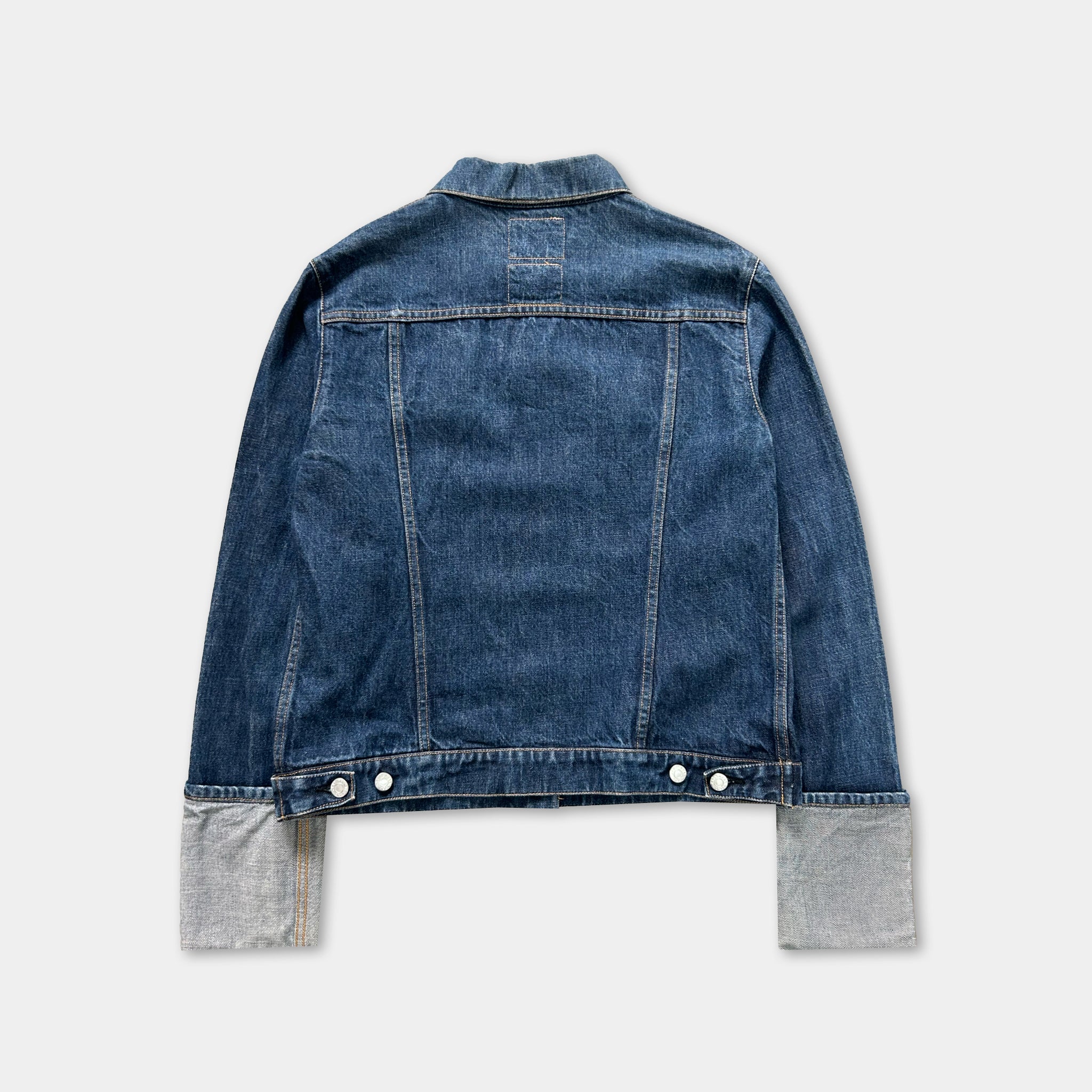 A denim jacket with a button-down front and two pockets, displayed against a white background.