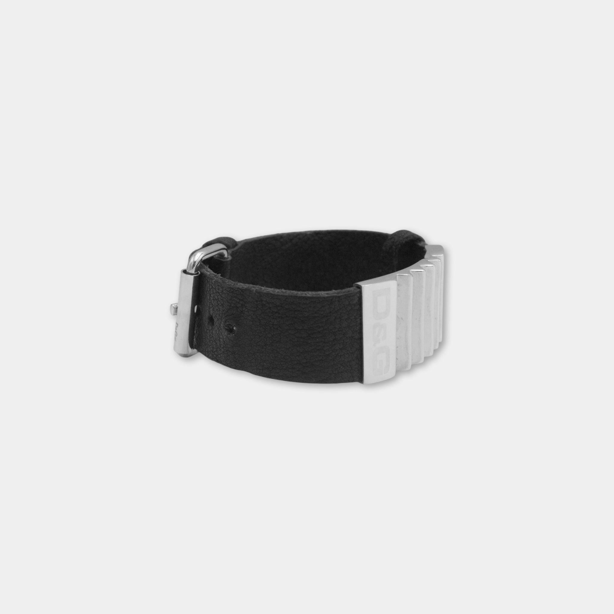A black leather bracelet with silver metal bars on it.