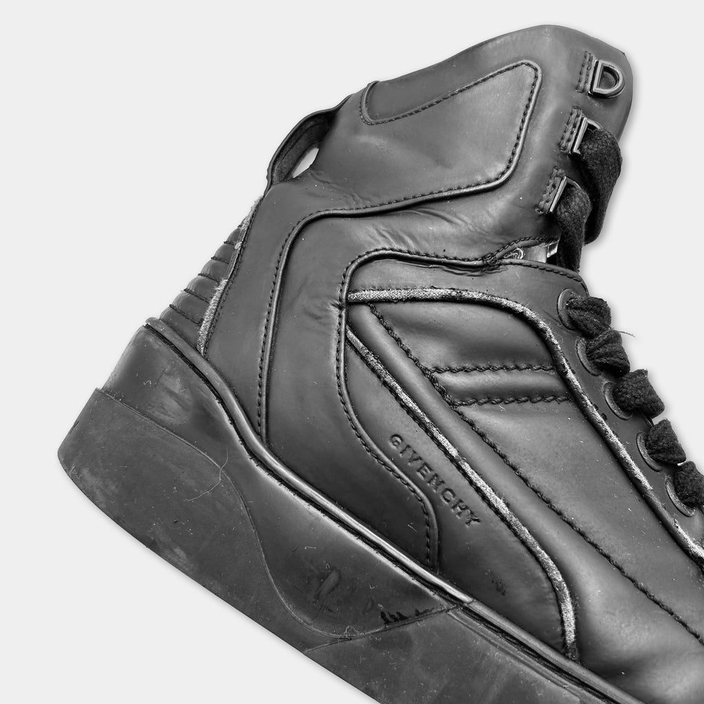A close-up view of a black leather shoe with the brand name "GIVENCHY" visible on the side.