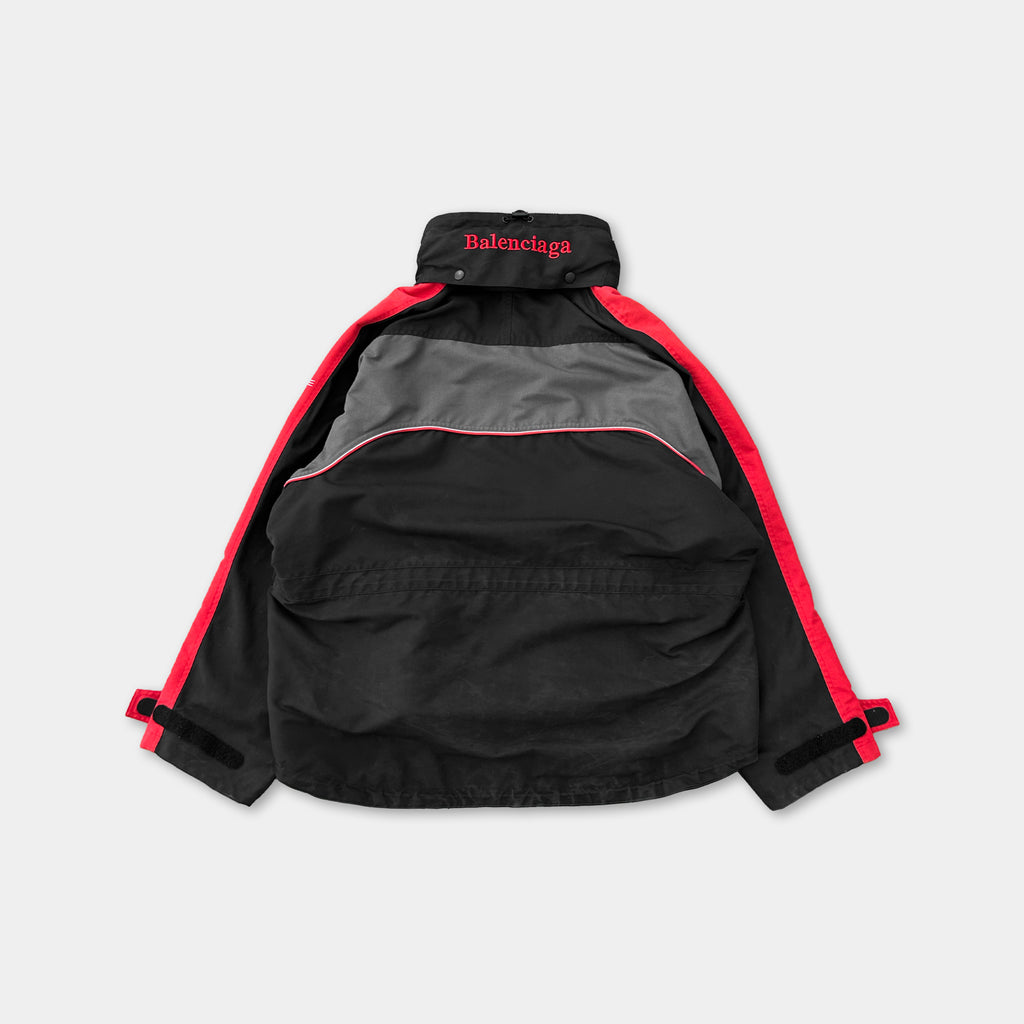 A black and red jacket with the Balenciaga logo on the collar.