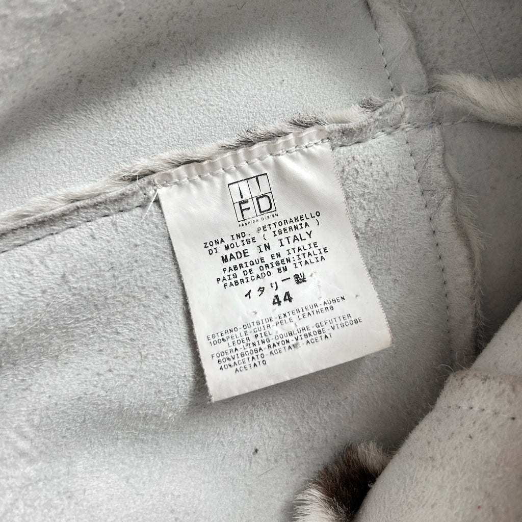 a close-up view of a white label with text on it, attached to a fabric surface.