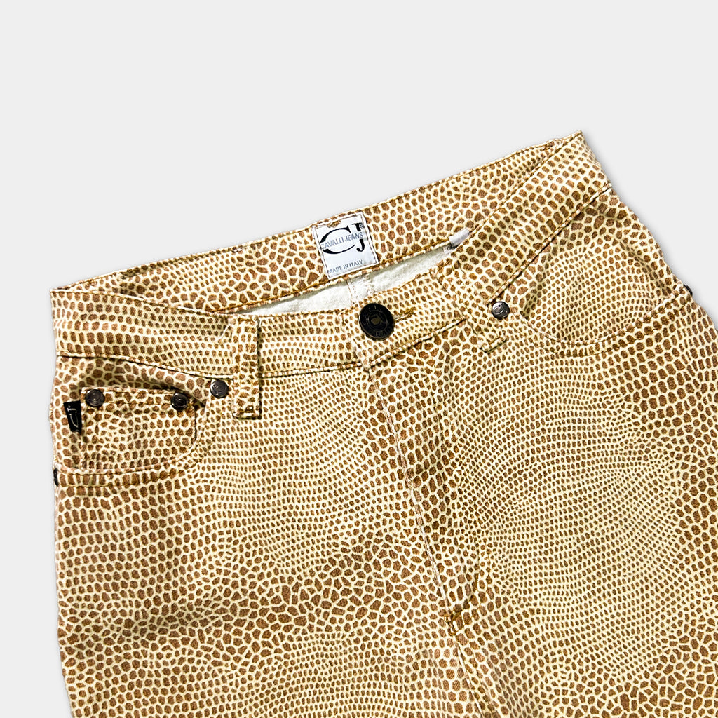 A pair of tan-colored, patterned pants with a label on the waistband.