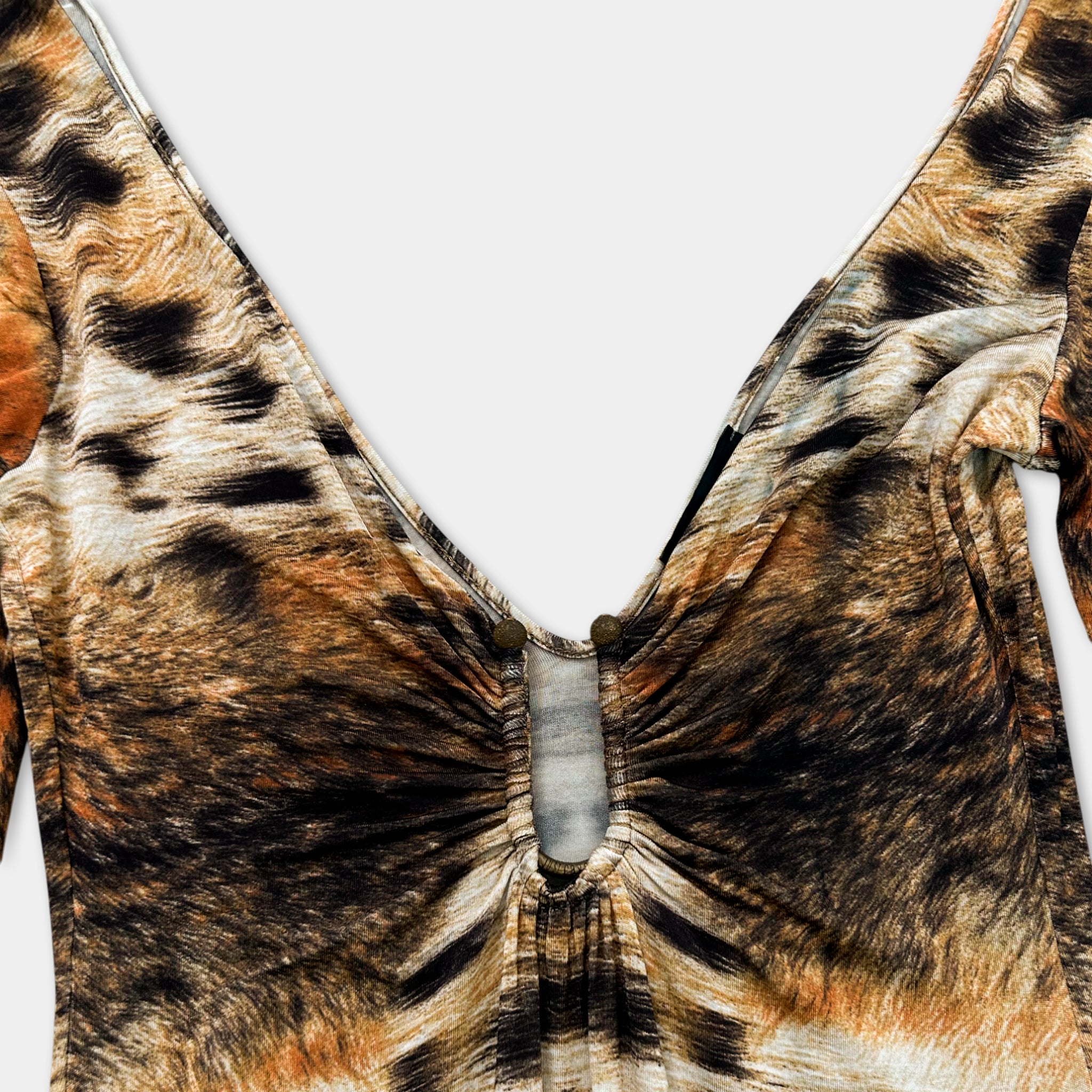 A close-up view of a patterned fabric with a v-neck design, featuring a central opening.