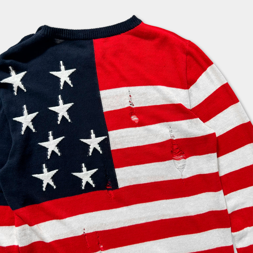 A close-up view of a sweater with a red, white, and blue pattern resembling the American flag.