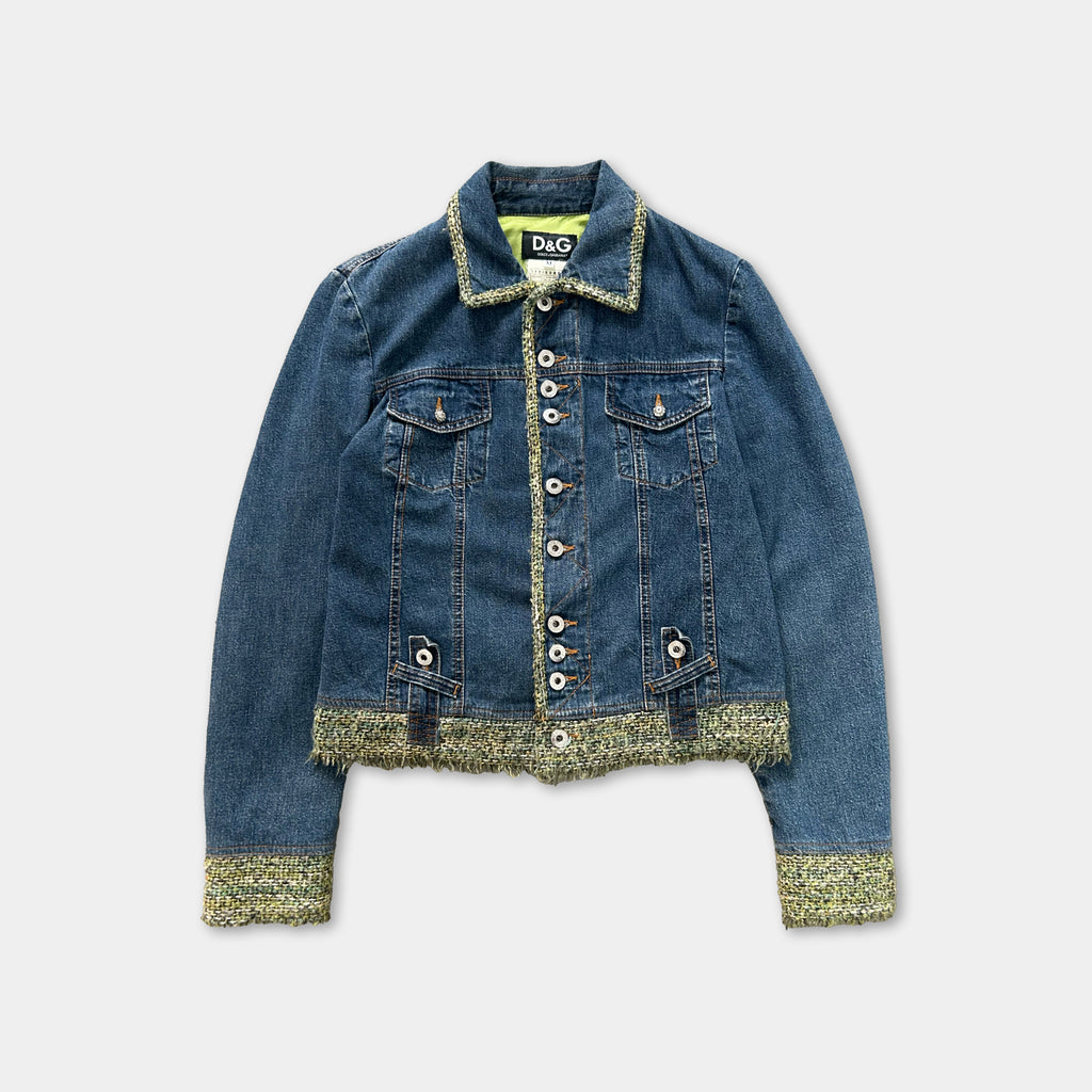 A denim jacket with a button-down front and fringed trim, featuring a yellow collar and buttons.