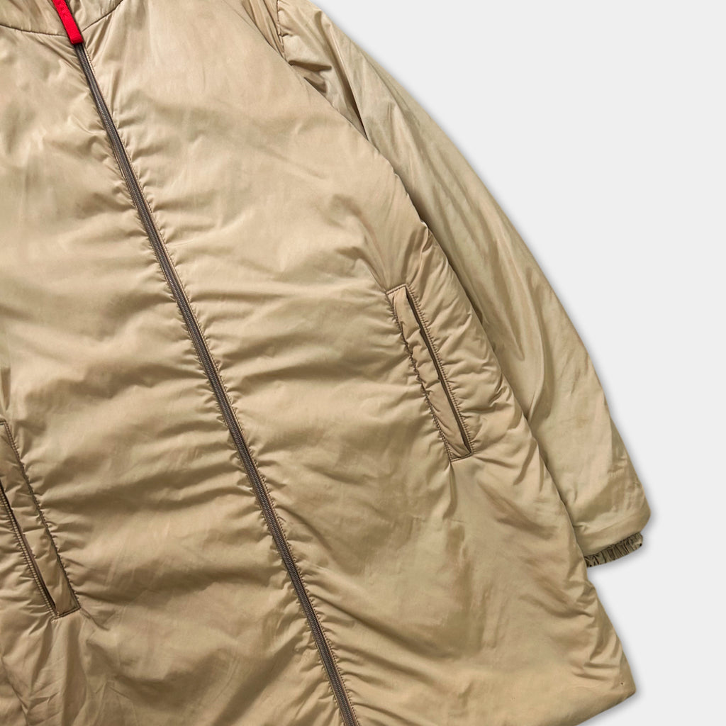 A tan-colored jacket with a zipper and a small pocket on the front.